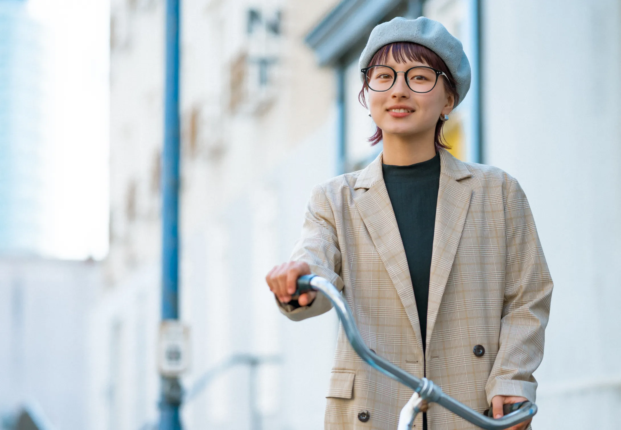 自転車にまたがるベレー帽の女性